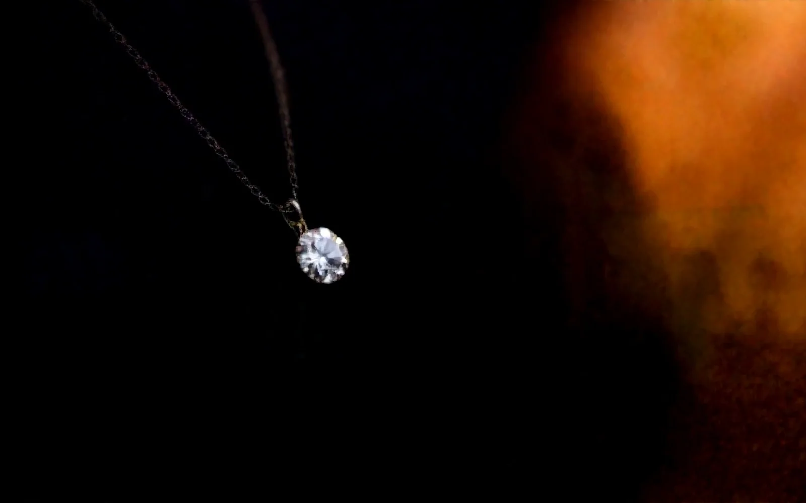 A fine diamond pendant necklace on dark velvet